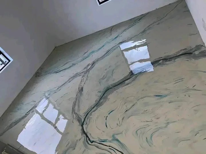 Cream and teal marble-effect metallic epoxy floor reflecting window light in an empty room